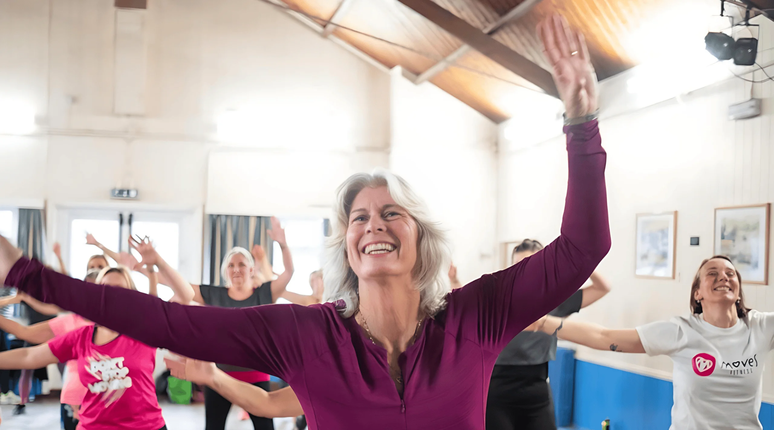 Happy seniors participating in a group fitness class at Moves Fitness.
